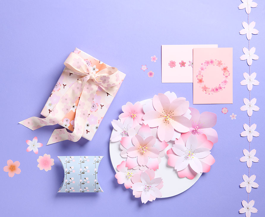 Geschenk und Karten mit Kirschblütendesign auf lila Hintergrund