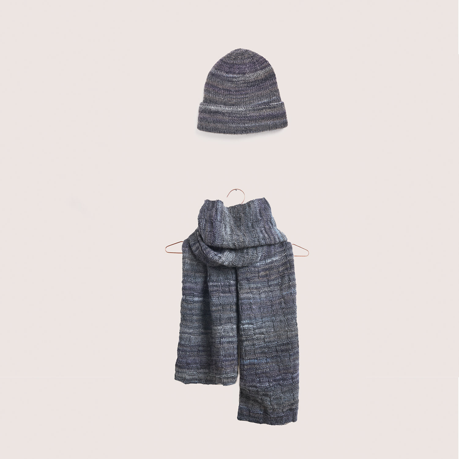 Strickset bestehend aus einer grauen Mütze und einem Schal, Modell 24 + 25 aus Wonderball Special. Die Vorderansicht zeigt die hochwertige Verarbeitung und das elegante Design.