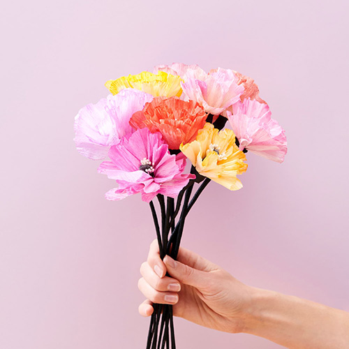 DIY Papierblumen werden in einer Hand gehalten