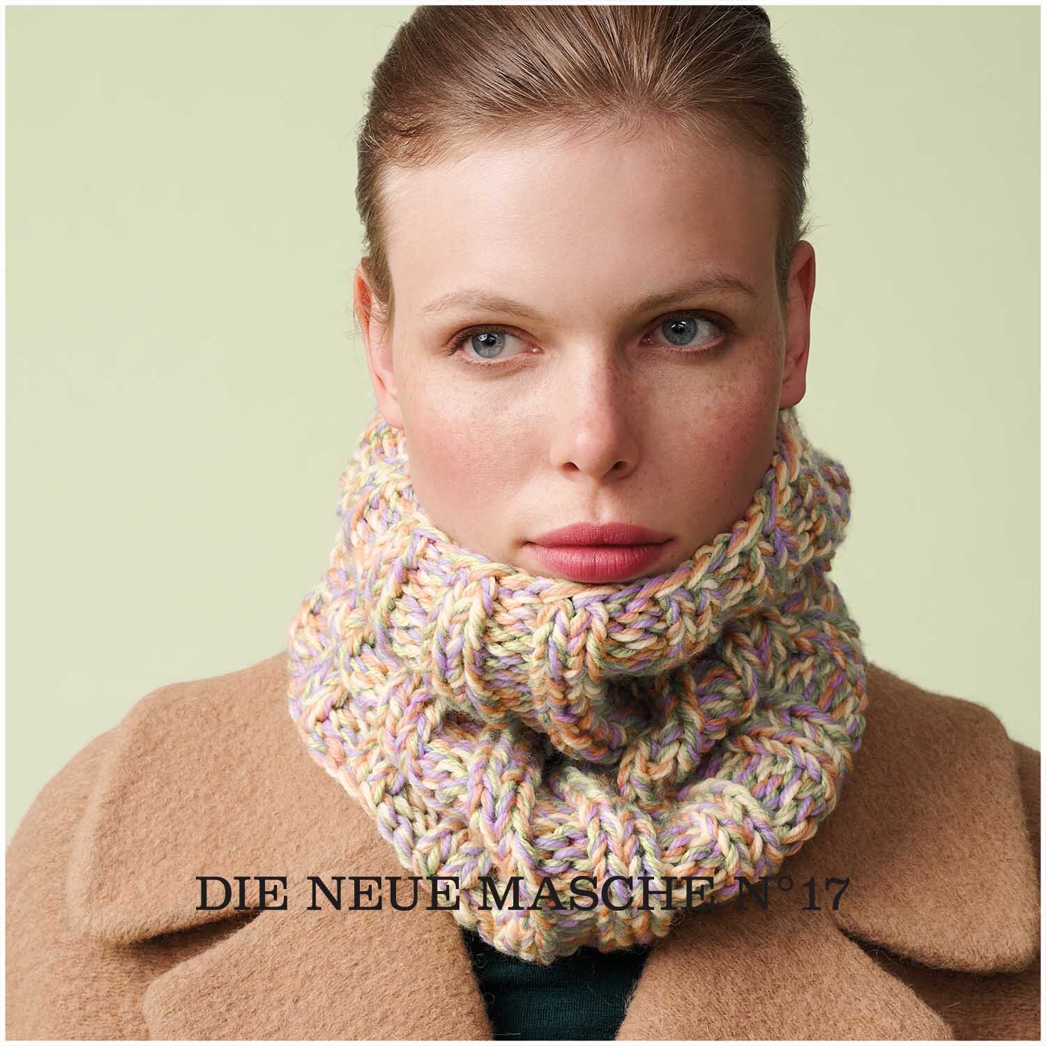 Soft Merino: Frau trägt gestrickten Schal in Pastelltönen, ideal für kalte Tage. Wolle Rödel.