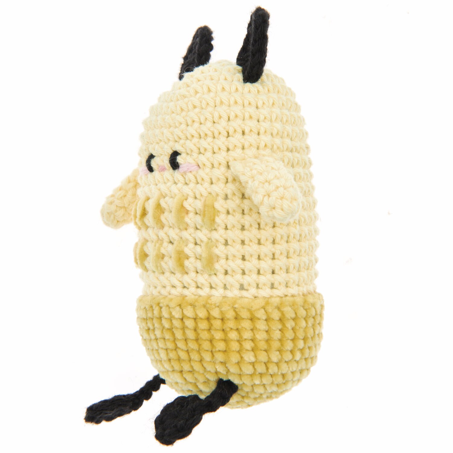 Ricorumi Nilli Nilli, ein gehäkeltes Spielzeug in Vanille und Senf mit schwarzen Details. Perfekt für kreative Handarbeitsprojekte.