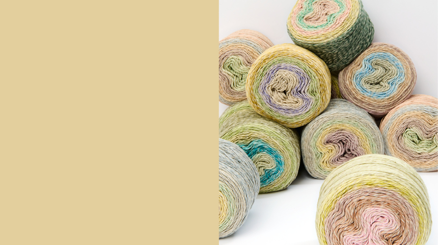 Ein gelber Farbauschnitt, daneben Garne in pastelligen Farben
