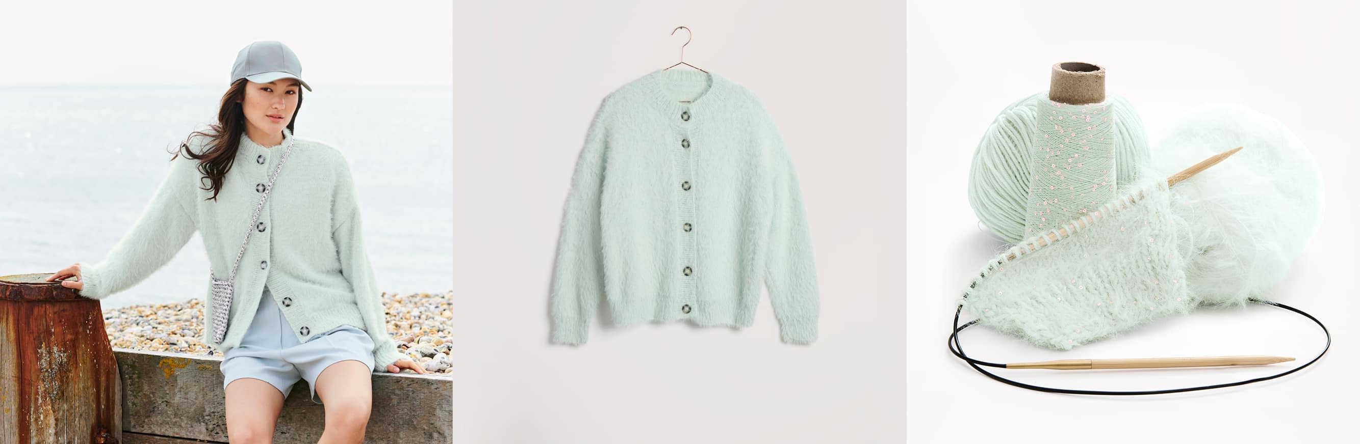 Gestrickte Jacke Modell 27 aus Lovewool No. 22 getragen von einer Frau und platziert auf einem Bügel. Daneben Wollknäuel in Hellblautönen und Strickstück an Rundstricknadeln.