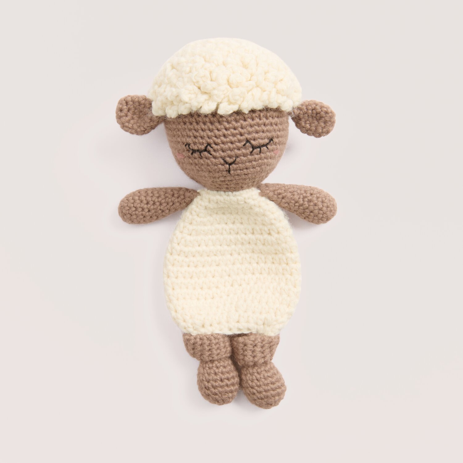 Rico Baby 044 Rico Baby Dream dk uni - A Luxury Touch gehäkeltes Schaf in Offwhite Nougat, liegend vor hellem Hintergrund, Garnangabe 50g 115m, Marke Rico Design