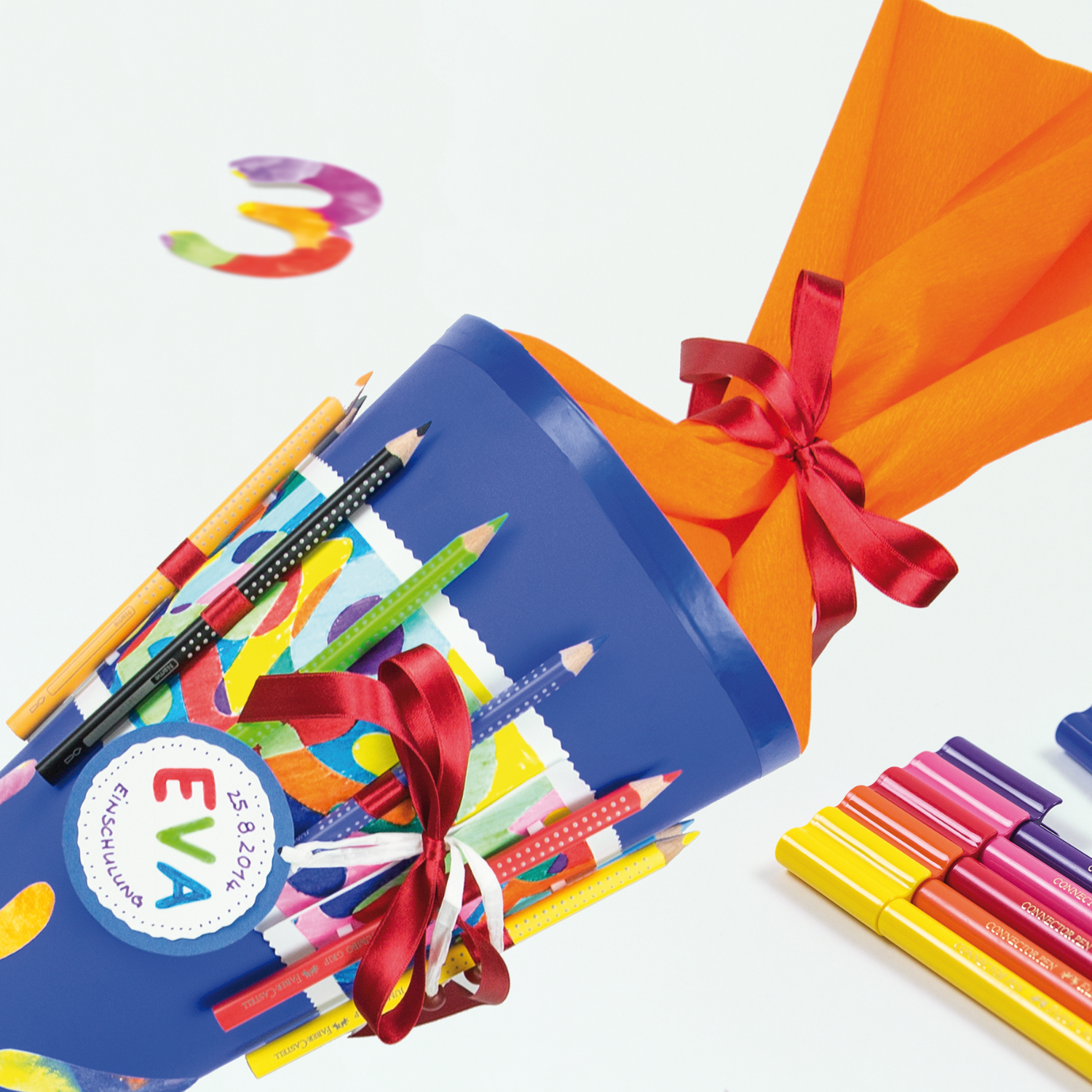 Jumbo Grip Farbstift in einer bunten Schultüte mit roten Schleifen, umgeben von weiteren Farbstiften.