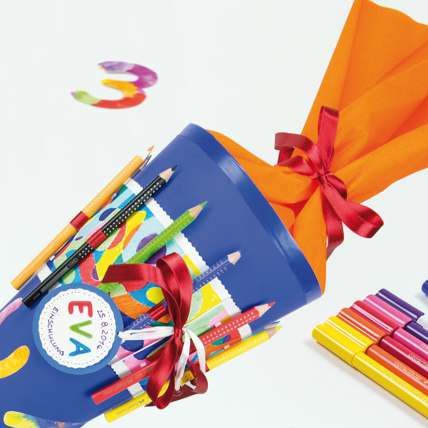 Jumbo Grip Farbstift von Faber Castell in einer bunten Schultüte mit roten Schleifen und farbigen Stiften.