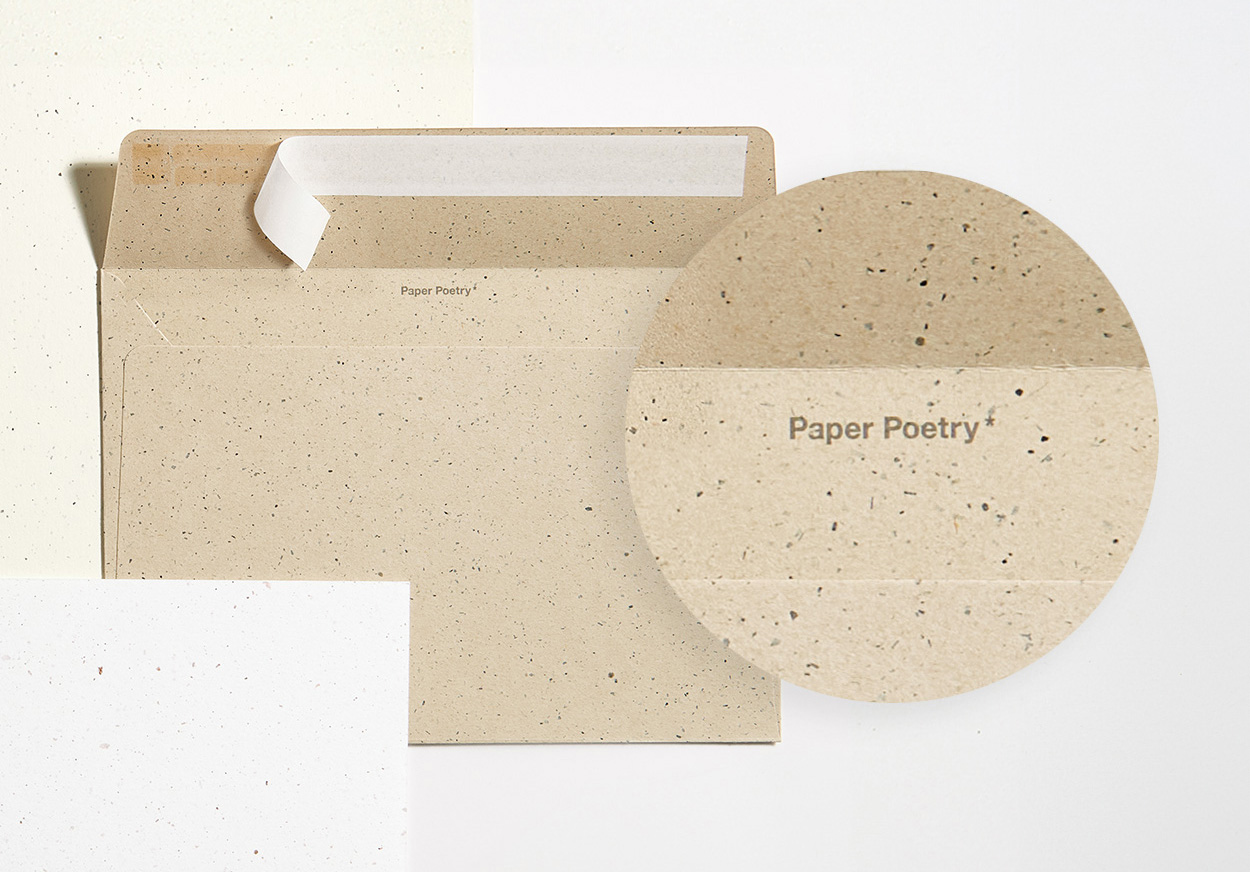 Brauner Umschlag mit passender Karte und Close-Up von Schriftzug im Umschlag. Flatlay von Produkten.