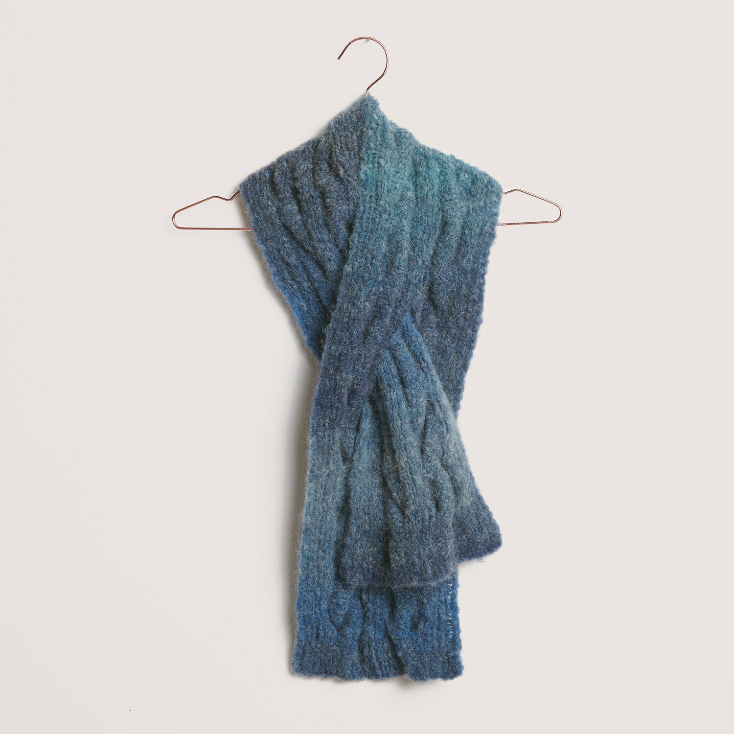 Die Neue Masche No. 14 Winter von idee. Creativmarkt Fashion Alpaca Superfine Heavens Big Cloud Schal in Blau, aus weichem Garn, hängt elegant auf einem Kleiderbügel.