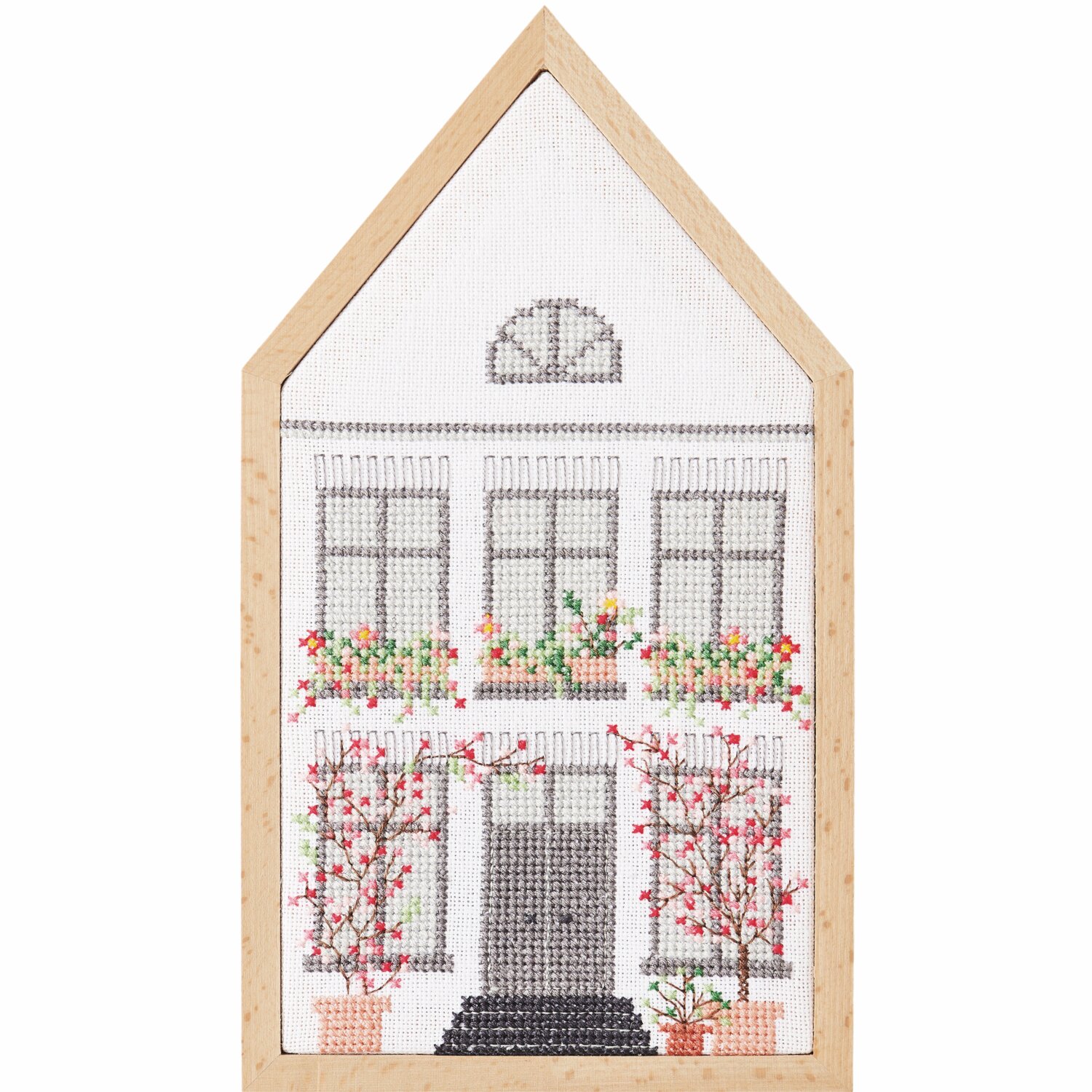 Stickbuch Futschikato 183: Kreuzstichbild eines Hauses mit Blumen, gerahmt in Holzoptik.