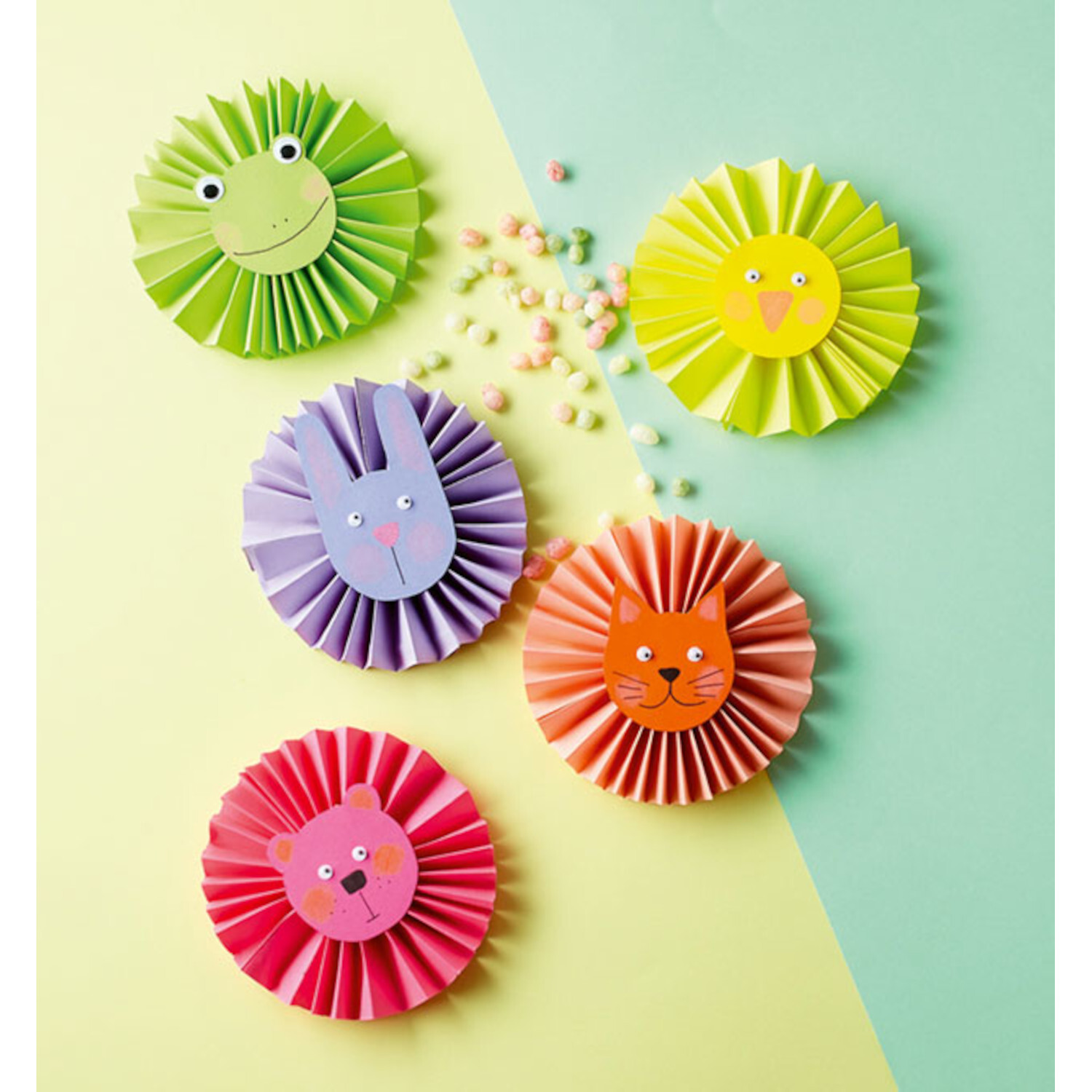 365 Rund-ums-Jahr-Bastelideen: Bunte Papierrosetten in Tierform auf zweifarbigem Hintergrund.