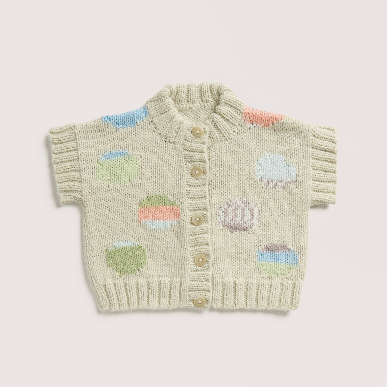 Rico Baby 042 Sprachauswahl deutsch von Rico Design Strickset Weste Modell 22 aus Baby 042 in Salbei mit bunten Mustern und Knöpfen, gestrickt aus Rico Baby Dream dk uni - A Luxury Touch.
