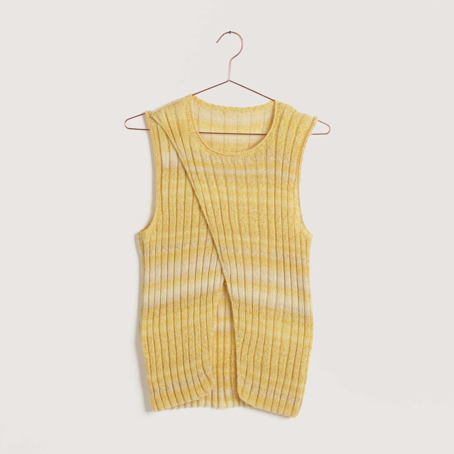 Strickset Top Modell 07 aus Lovewool No. 22: Gelbes, ärmelloses Oberteil aus Baumwolle, elegant drapiert auf einem Kleiderbügel.